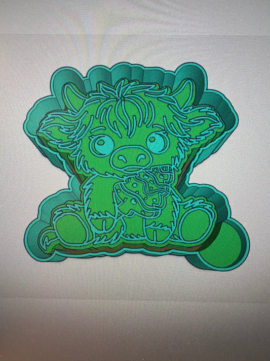 Highland holding a Christmas Cake Mold